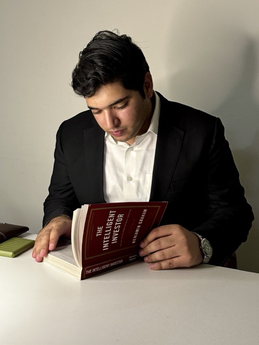 Husnain reading The Intelligent Investor by Benjamin Graham