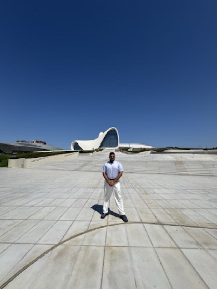 Husnain standing on the plaza in front of the Heydar Aliyev Center