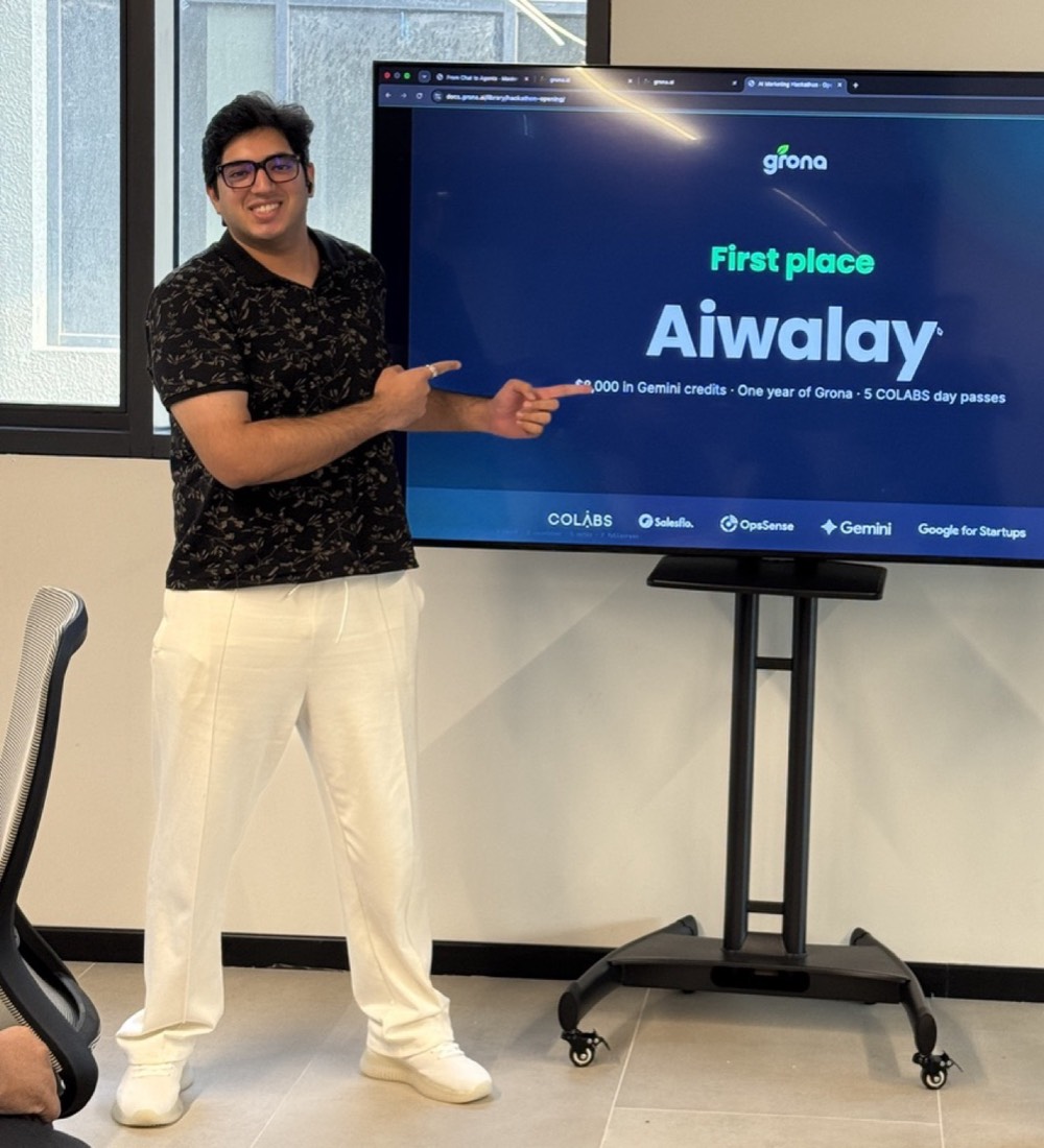 Husnain pointing to the First place, Aiwalay result on screen at the AI Marketing Hackathon