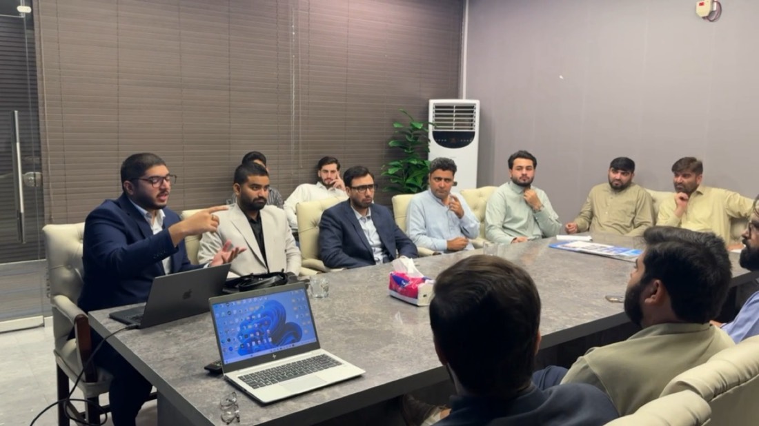 Husnain leading an AI session around a boardroom table