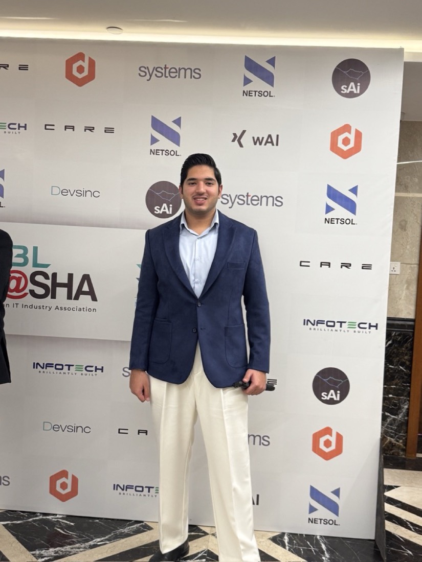 Husnain at a P@SHA Pakistan IT Industry Association event backdrop